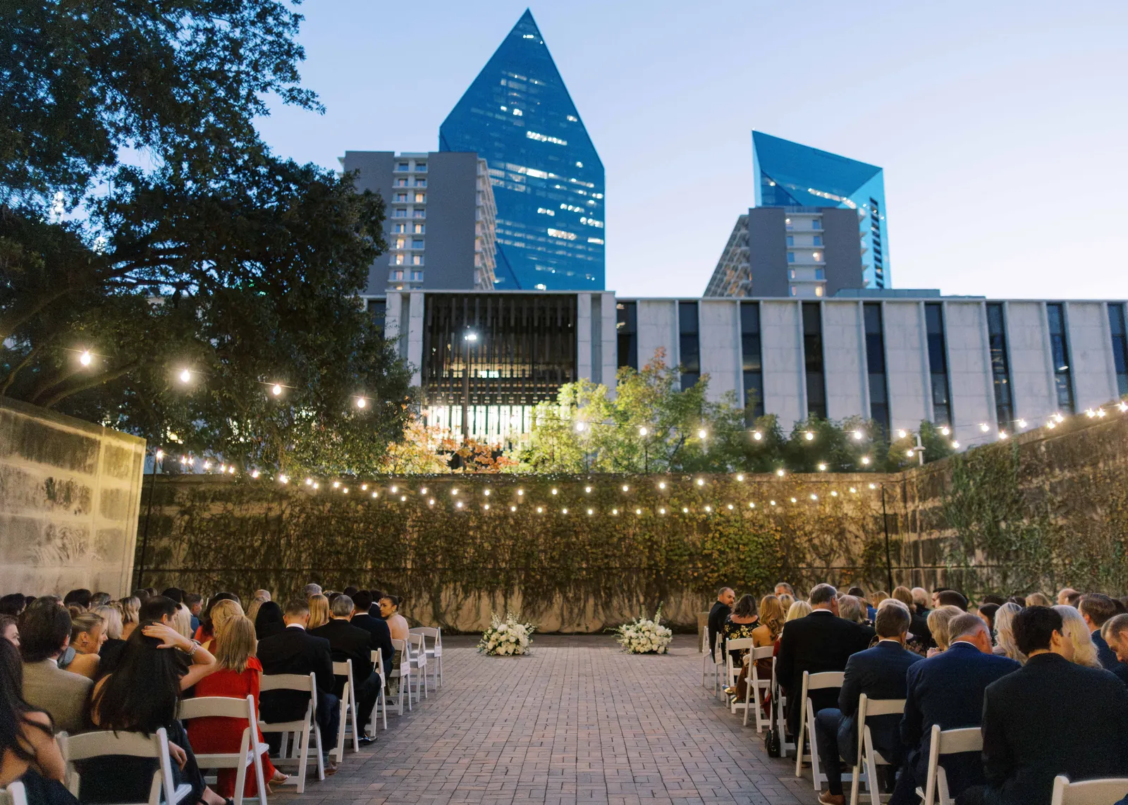 An outdoor ceremony beneath string lights