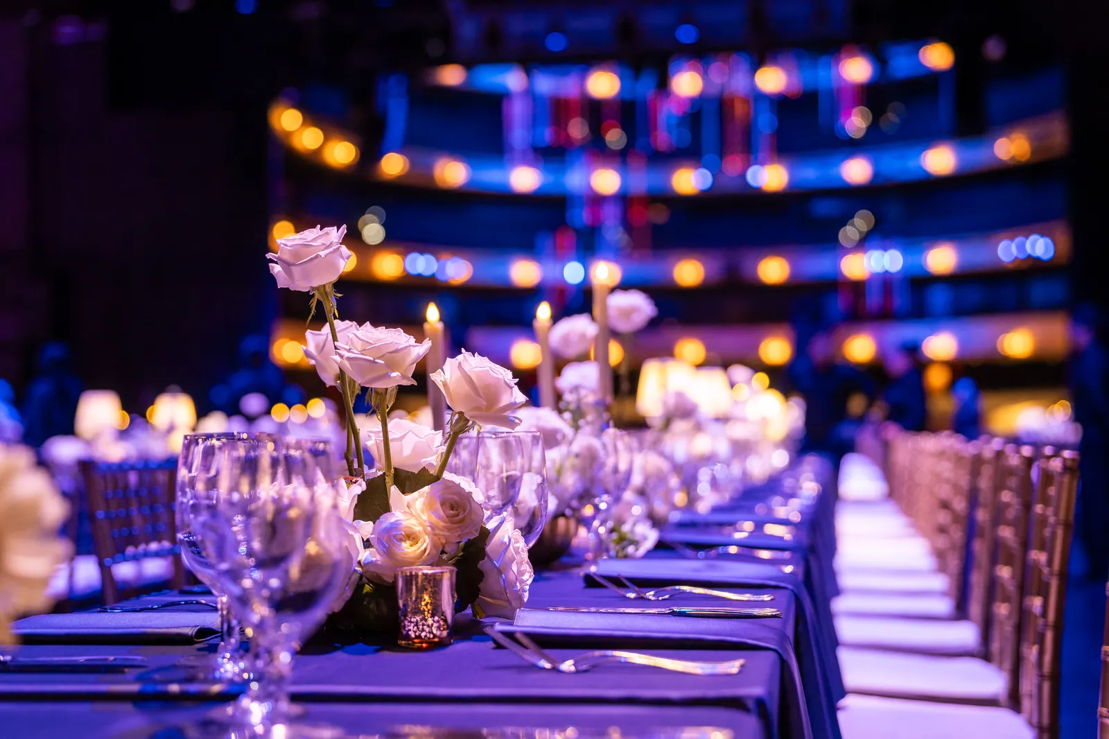 A tablescape lit in purple and blue