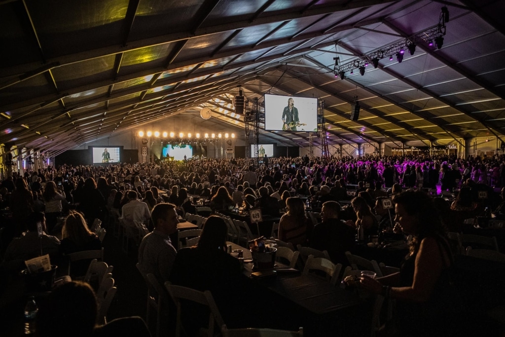 Concert with a full stage inside a tent for rain